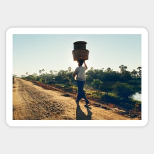 Woman Carrying Baskets on Head Walking in Burmese Countryside in Beautiful Morning Light Sticker